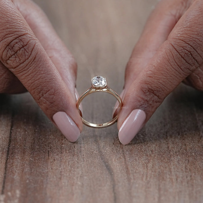 close up view of oval cut diamond button back solitaire engagement ring