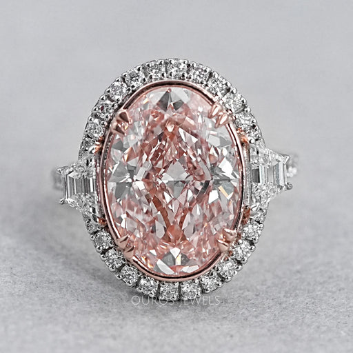 front view of pink oval diamond with trapezoid accent halo diamond ring