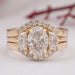 front view of oval-cut lab diamond solitaire bridal ring set with yellow gold band