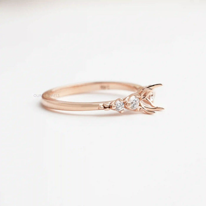 side view of flower-shaped semi-mount round diamond engagement ring on fabric