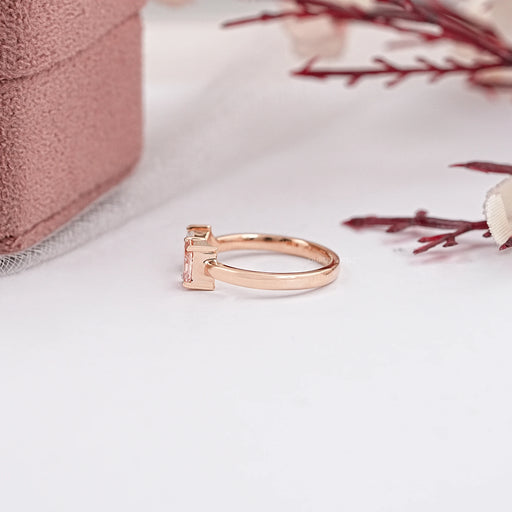 side view of pear and radiant-cut lab diamond toi et moi wedding ring on fabric