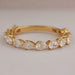front view of pear cut lab grown diamond half eternity wedding band yellow gold