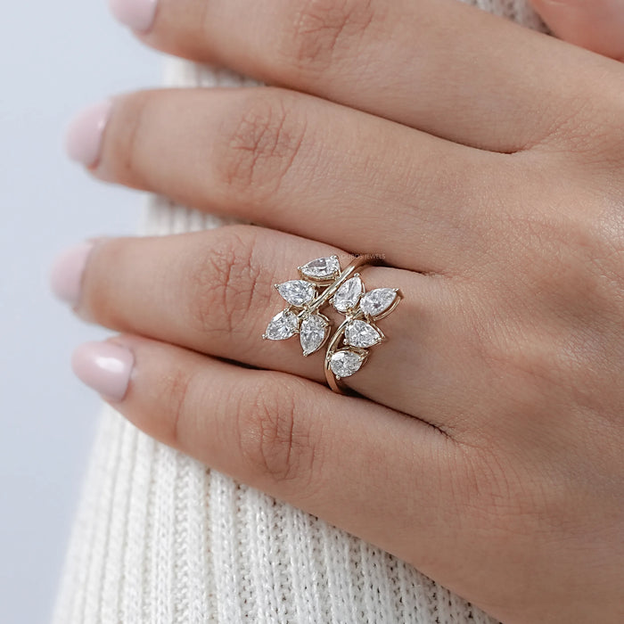 pear-cut lab-grown diamond leaf design cluster engagement ring on model's finger