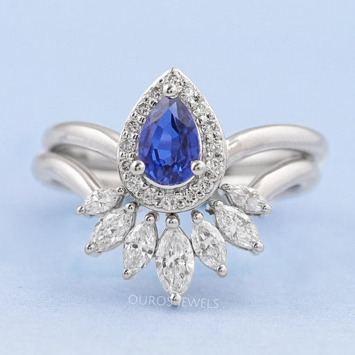 front view of sapphire pear gemstone with marquise diamond carved wedding band