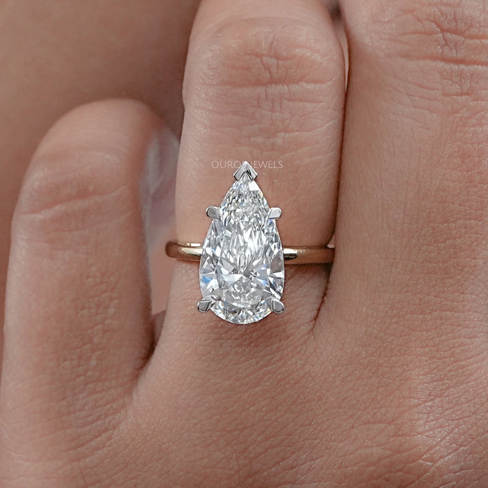 front view of pear shape diamond solitaire 5 prong engagement ring in finger