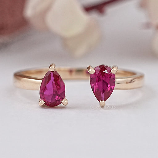 front view of pear-cut ruby gemstone dainty wedding ring with yellow gold band