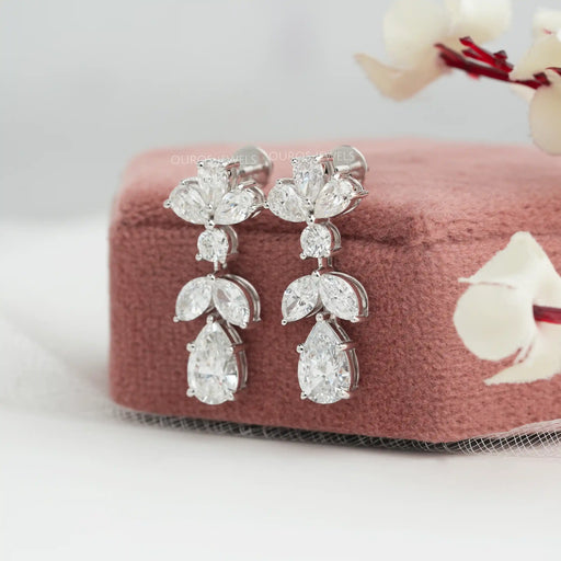 side view of pear and marquise cut diamond prong setting flat back drop earrings