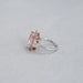 side view of pink cushion-cut lab diamond halo 3 stone colored engagement ring