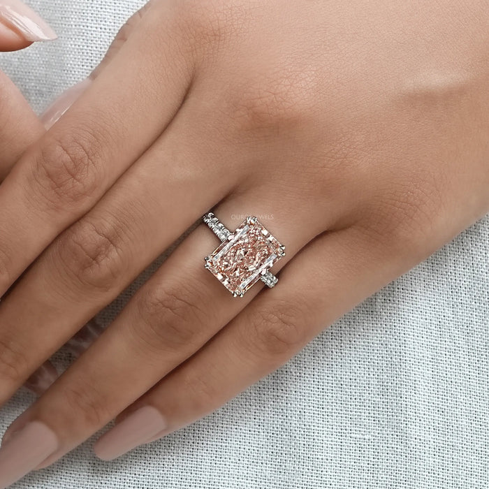 pink radiant-cut diamond double-prong solitaire accent engagement ring in finger