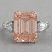 front view of pink emerald diamond three-stone hidden halo colored engagement ring