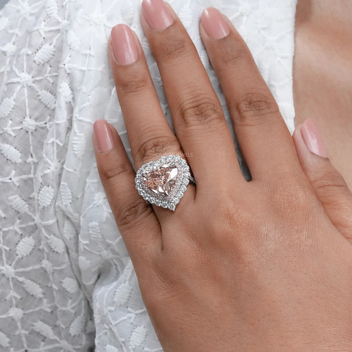 pink heart cut lab diamond double halo engagement ring in finger