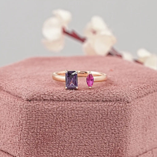 emerald and marquise-cut gemstone toi et moi open wedding ring on jewelry box