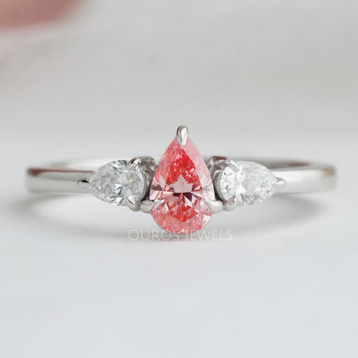 front view of pink pear cut lab diamond three stone engagement ring