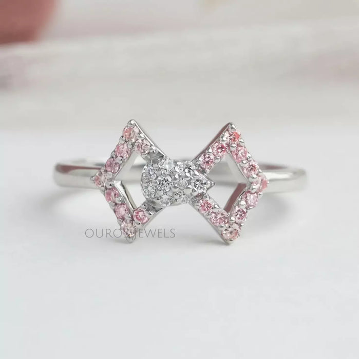 front view of round-cut lab-grown diamond classic wear bow ring pink on fabric