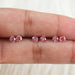 pink round shaped loose lab created diamonds shown on finger