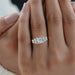 princess and baguette cut lab diamond five stone engagement ring in finger