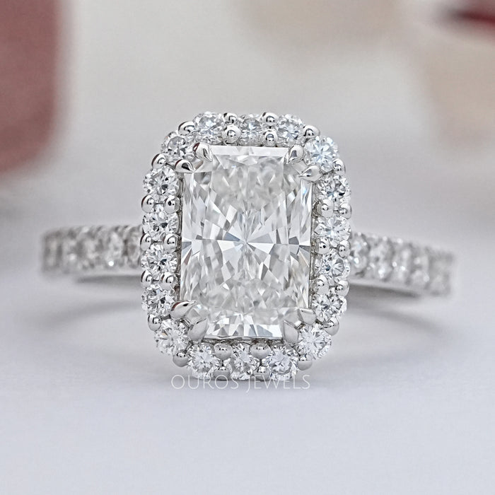 radiant cut lab diamond halo engagement ring's front view angle on grey fabric