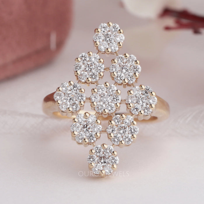 front view of round-cut lab diamond flower cluster engagement ring on fabric