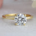 front view of round cut diamond hidden halo solitaire engagement ring yellow gold