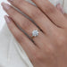 twisted round-cut lab diamond solitaire accent anniversary ring on model's finger