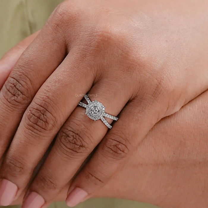 front view of round diamond crossover halo engagement ring in finger