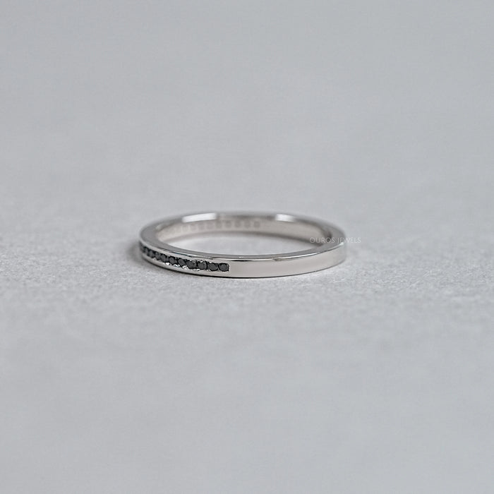 left view of black round-cut diamond channel-set half eternity band engagement ring