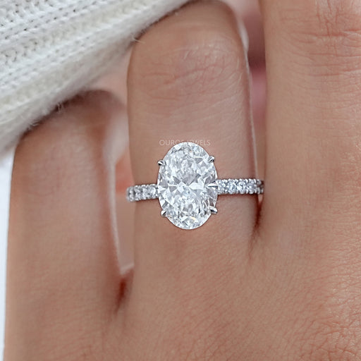 front view of oval cut diamond hidden halo solitaire engagement ring in finger