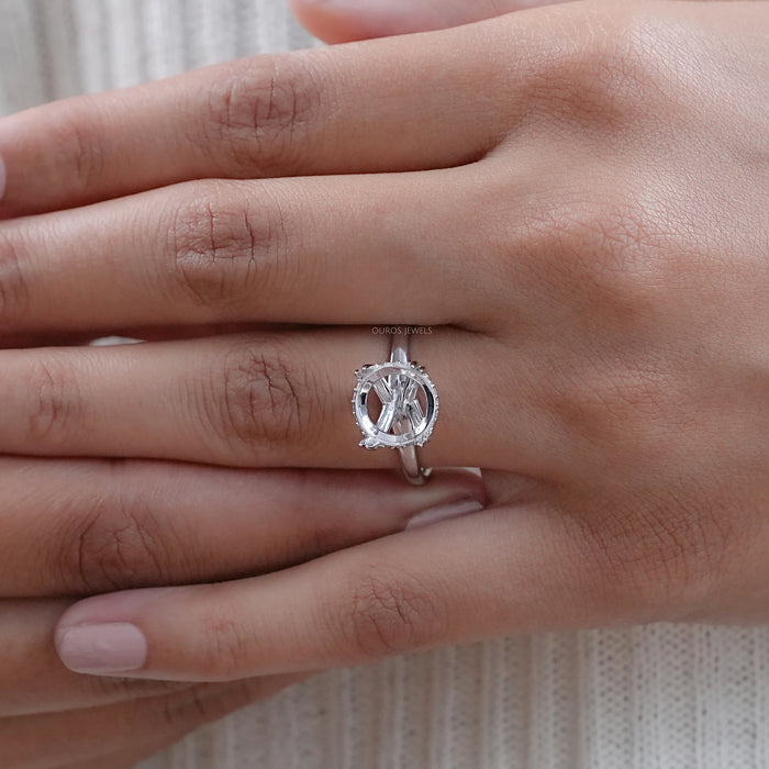 round shape hidden halo semi mount engagement ring in finger