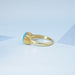 side view of east west blue oval cut gemstone wedding ring