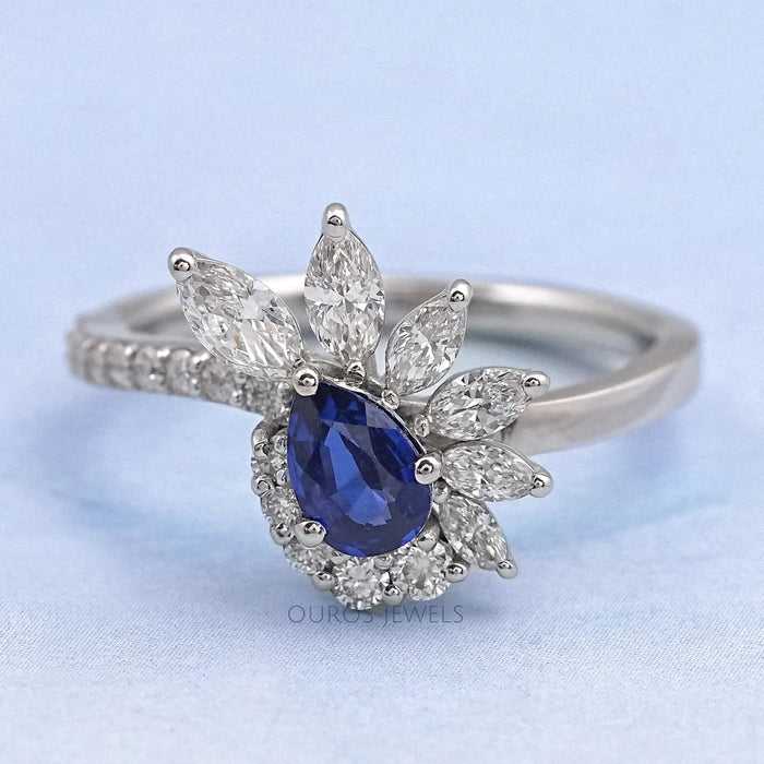 front view of pear cut blue sapphire gemstone cluster bypass engagement ring