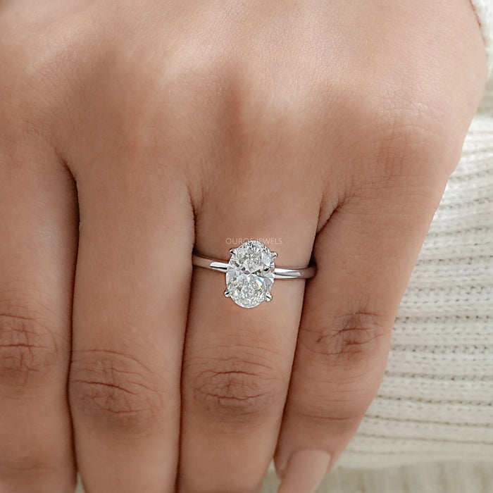 igi certified oval cut diamond solitaire engagement ring in finger