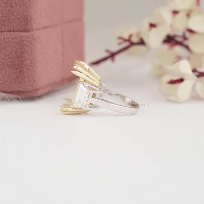 side view of step-cut trapezoid semi-mount three-stone wedding ring on fabric