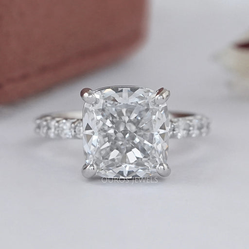 front view of square cushion-cut lab diamond eternity engagement ring on grey fabric