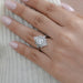 old european round cut diamond bezel set engagement ring in finger