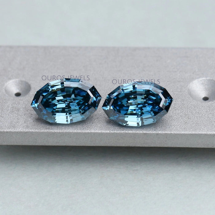 step cut blue oval cut manufactured diamonds pair on matte material