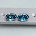 step cut blue oval cut manufactured diamonds pair on matte material