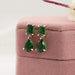 side view of green emerald and teardrop gemtsone flat back drop earrings
