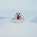 back view of oval ruby gemstone with heart diamond 3 stone engagement ring