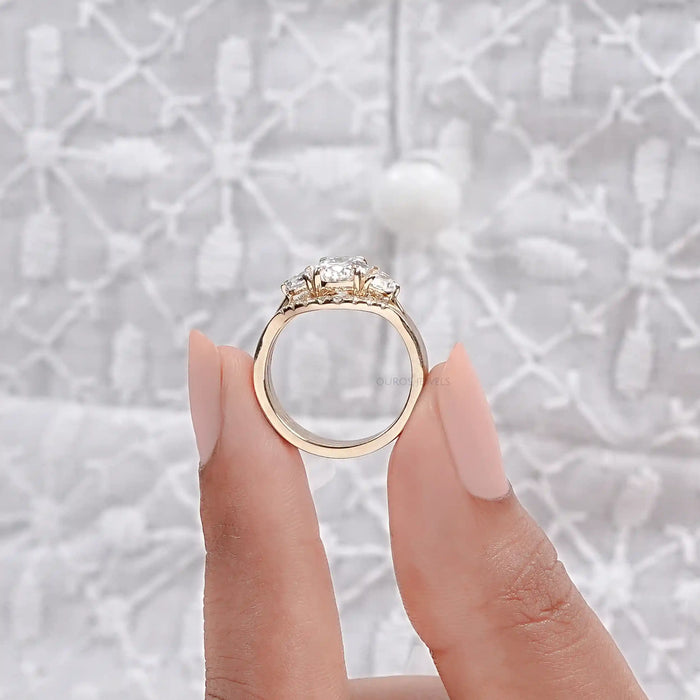 close view of oval-cut lab diamond solitaire bridal ring set with yellow gold band