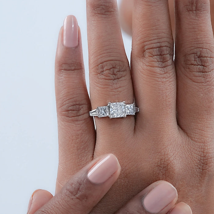 princess cut lab grown diamond five stone engagement ring in finger