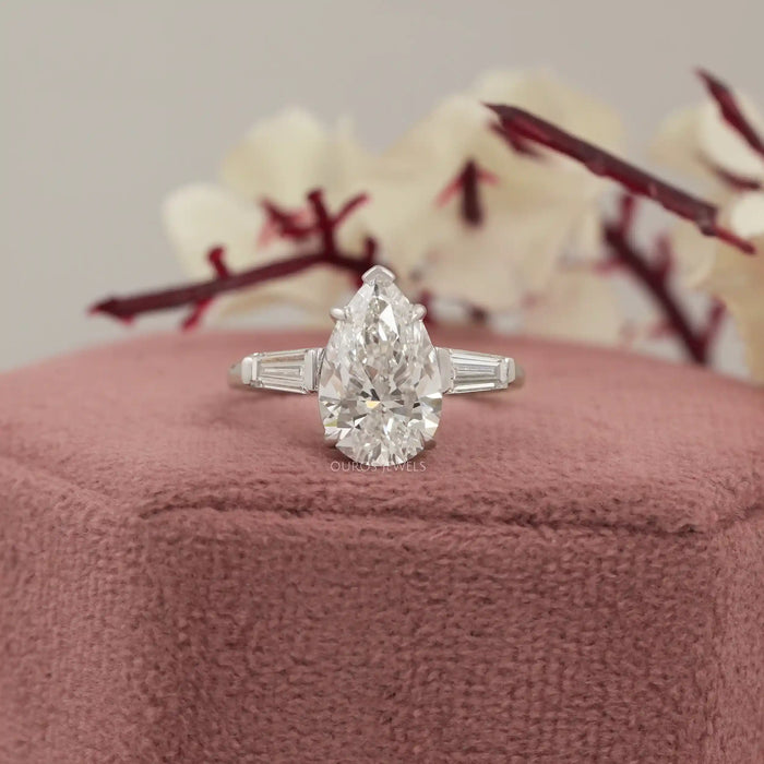 baguette side diamonds with pear cut three stone ring