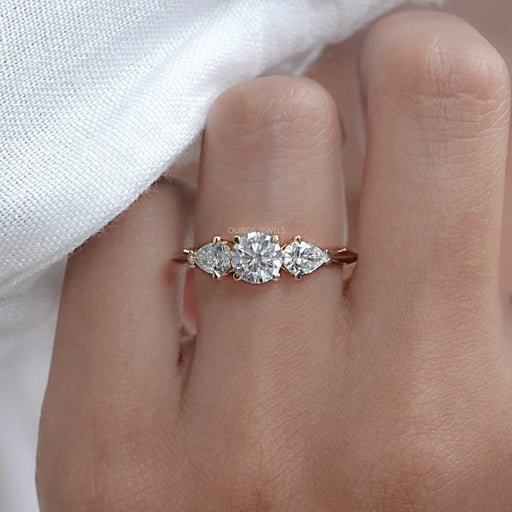 front view of 3 stone round cut lab diamond engagement ring in finger