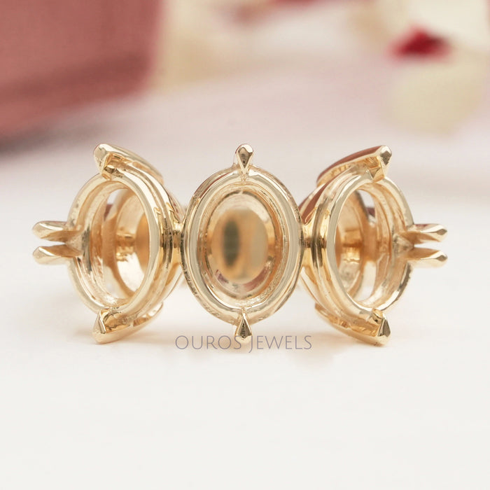 front view of oval-shaped semi-mount three-stone engagement ring