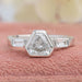 front view of three stone shield cut diamond bezel set engagement ring