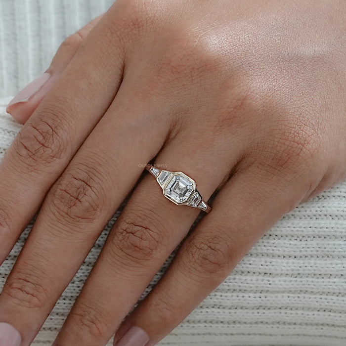 asscher and trapezoid cut lab diamond bezel five stone wedding ring in finger