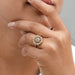 old cut round lab diamond flower halo engagement ring on model's finger