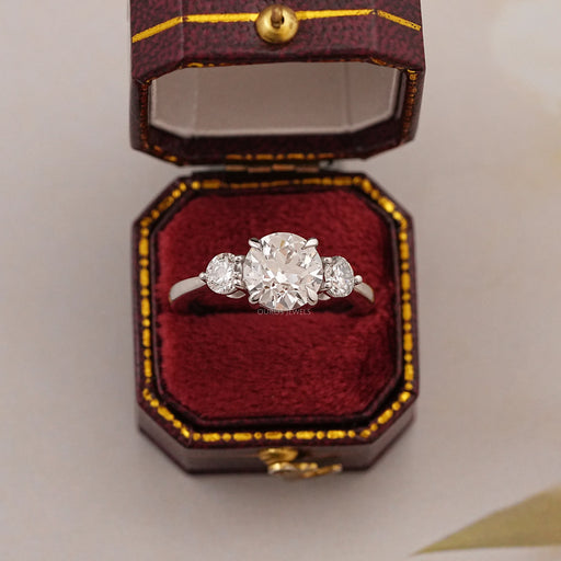 old european round cut diamond three stone engagement ring in jewelry box