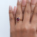 oval cut ruby lab gemstone bezel set solitaire ring on model's hand