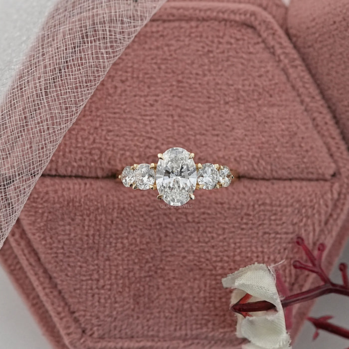 oval and round cut lab diamond five stone engagement ring in jewelry box