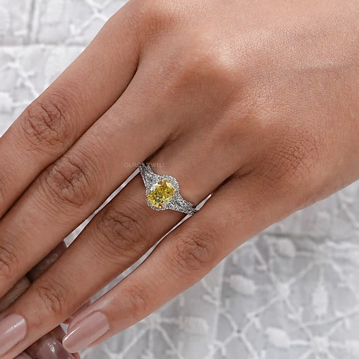 yellow oval cut diamond split shank halo engagement ring in finger view